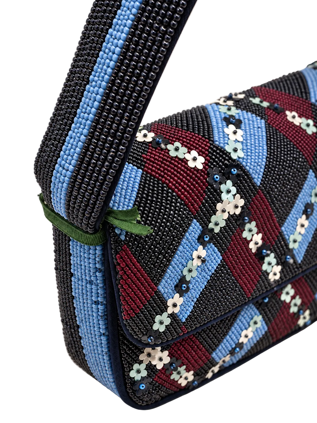 Close-up of a beaded shoulder bag with a geometric pattern of black, light blue, burgundy, and white floral beads, featuring a wide black and light blue beaded strap.