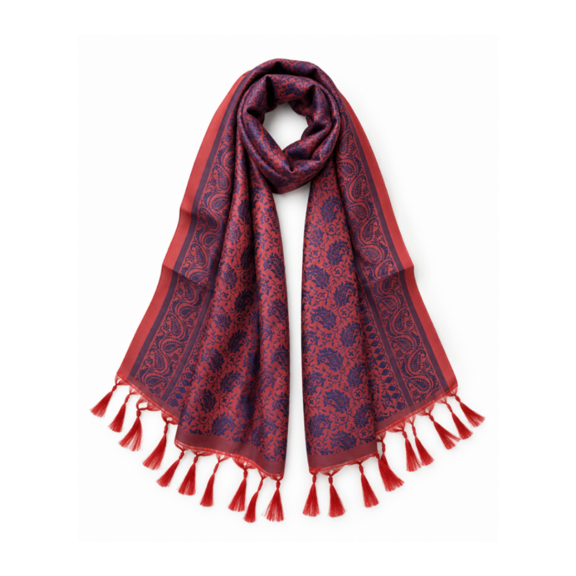 A red and navy blue paisley patterned scarf with tassel fringe, styled in a loop on a white background.