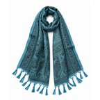A teal blue scarf with a black paisley and floral pattern, featuring tassel fringe on both ends, displayed against a solid white background.