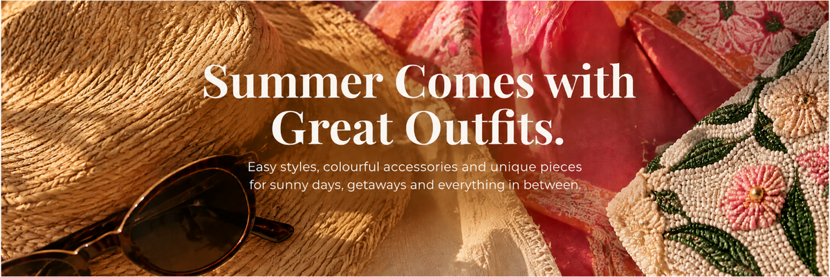 Promotional banner with the text 'Summer Comes with Great Outfits.' over a styled flat-lay of fashion accessories, including a woven straw hat, dark sunglasses, a pink patterned fabric, and a cream embroidered textile.
