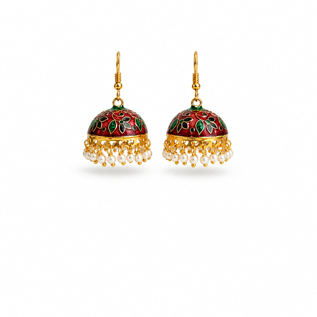 A pair of traditional Indian jhumka earrings with gold-plated hooks and frames, featuring a deep red and green floral enamel dome and dangling white pearl beads, shown on a plain white background.