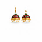 A pair of traditional Indian jhumka earrings with gold-plated hooks and frames, featuring a deep red and green floral enamel dome and dangling white pearl beads, shown on a plain white background.
