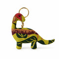 A fabric dinosaur keychain featuring a colorful pattern of green, yellow, and red, with a gold metal key ring, shown on a plain off-white background.