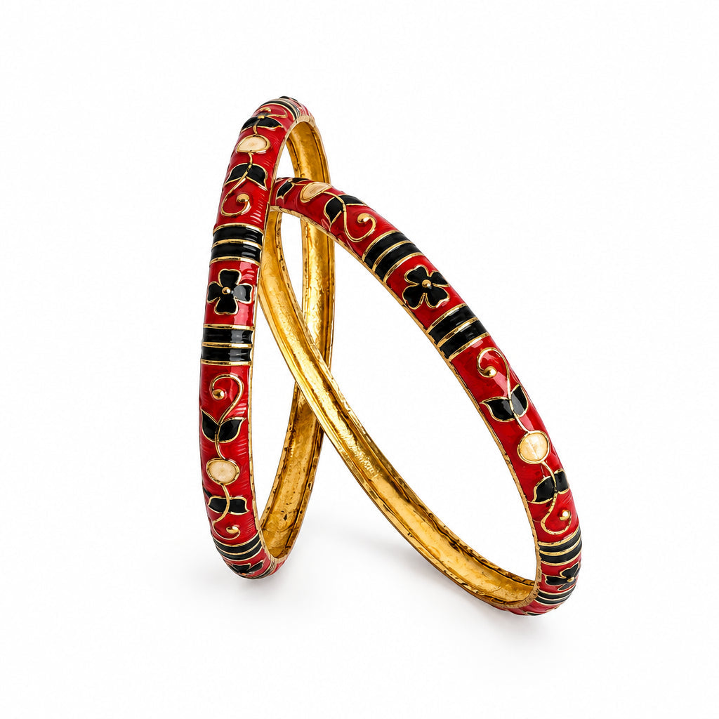 Two traditional Indian bangles, one red with black and gold floral patterns and the other gold-plated, displayed on a plain white background.