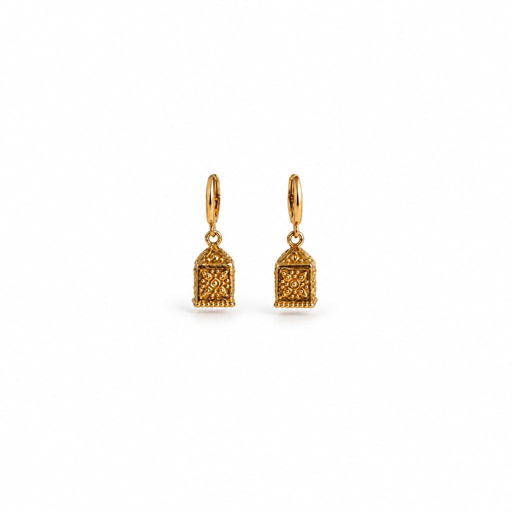 A pair of gold-toned drop earrings with a textured, ornate geometric pendant and a smooth hoop ear wire, shown on a clean white background.