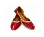 A pair of traditional red leather Juttis with gold embroidery and trim, displayed on a clean white background.
